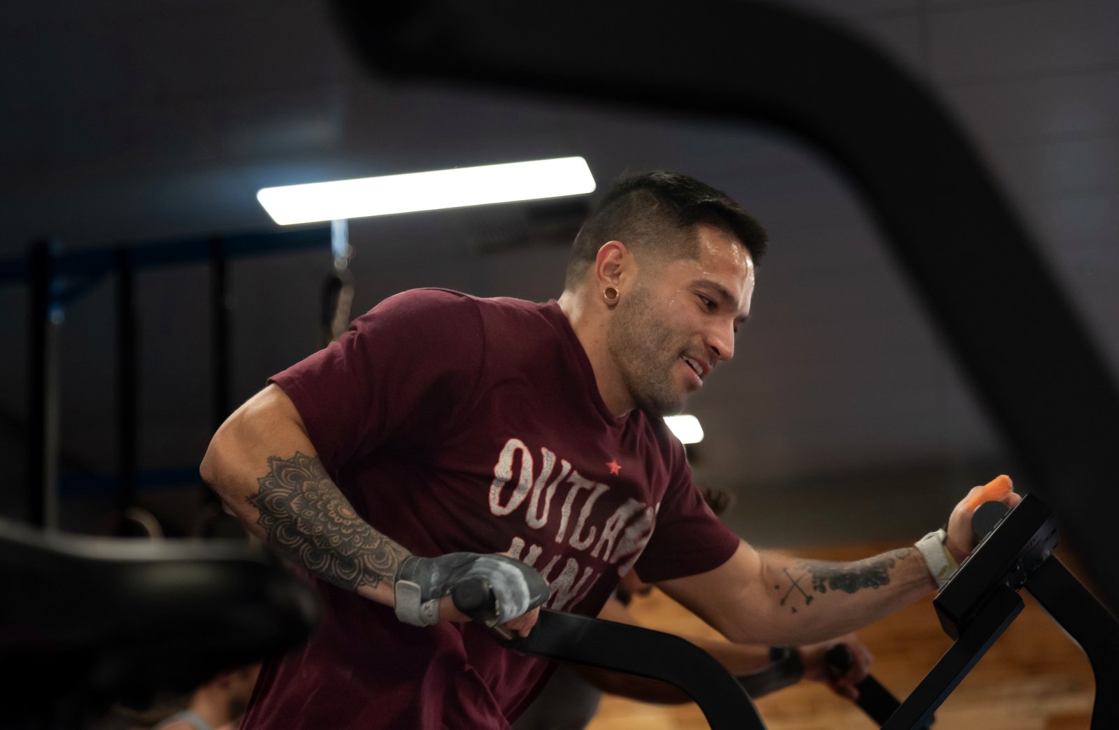 Member pushing hard on the assault bike, mid-workout, in a coached CrossFit class at Grandstand Perth